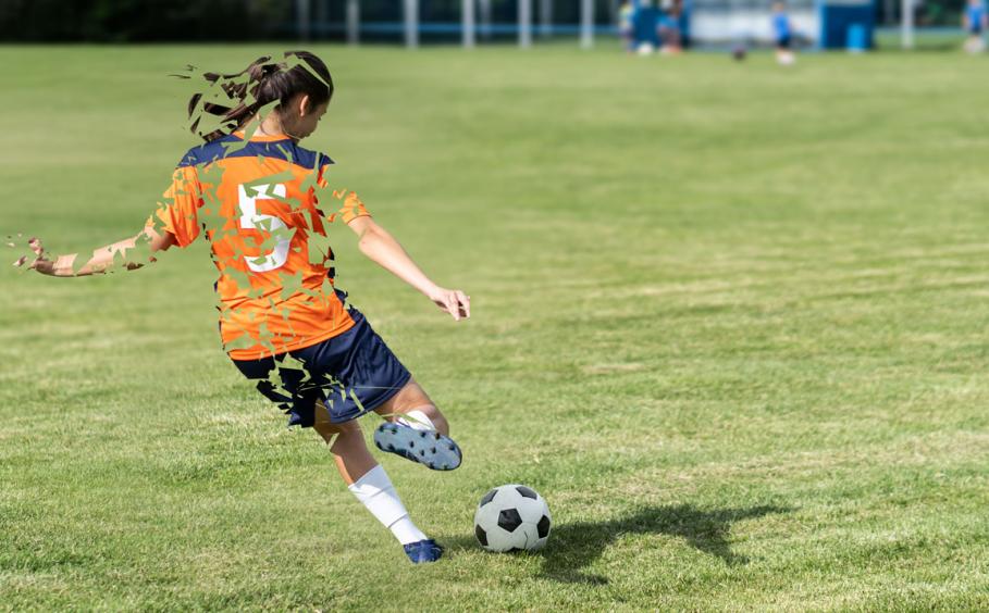 Young girl playing soccer