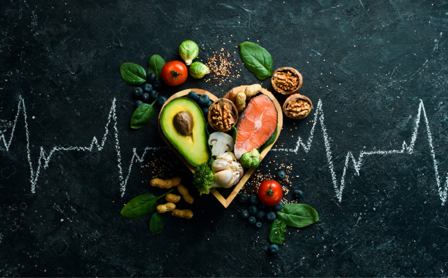 A chalk heart rate is drawn on a slate table with a food sitting in a heart shaped bowl in the middle.